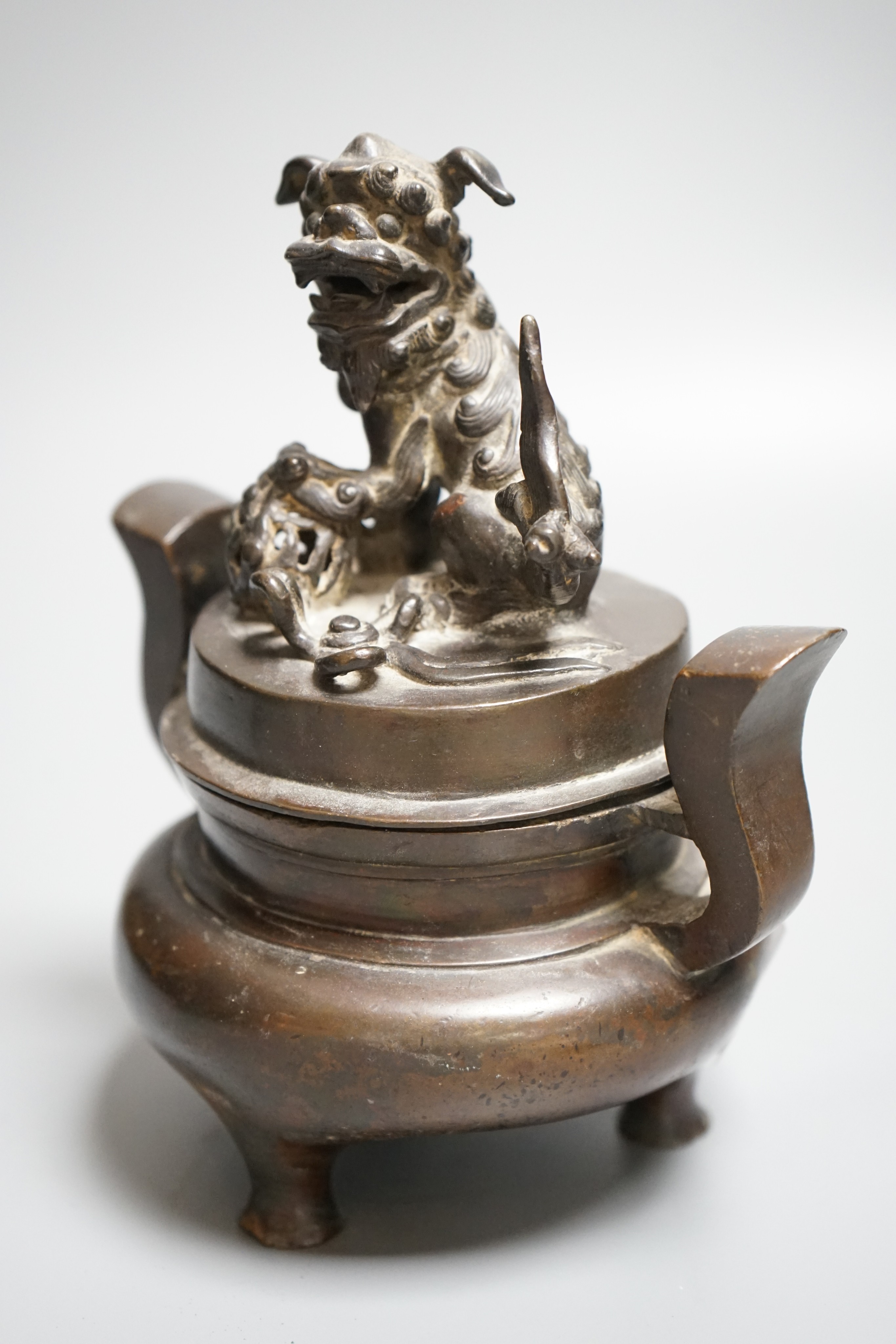 A Chinese copper alloy censer and cover with lion dog cover, height 20cm